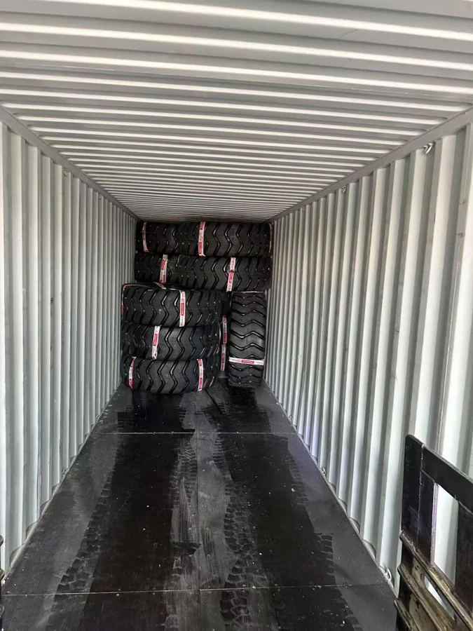 23.5-25 tires being packed in a shipping container